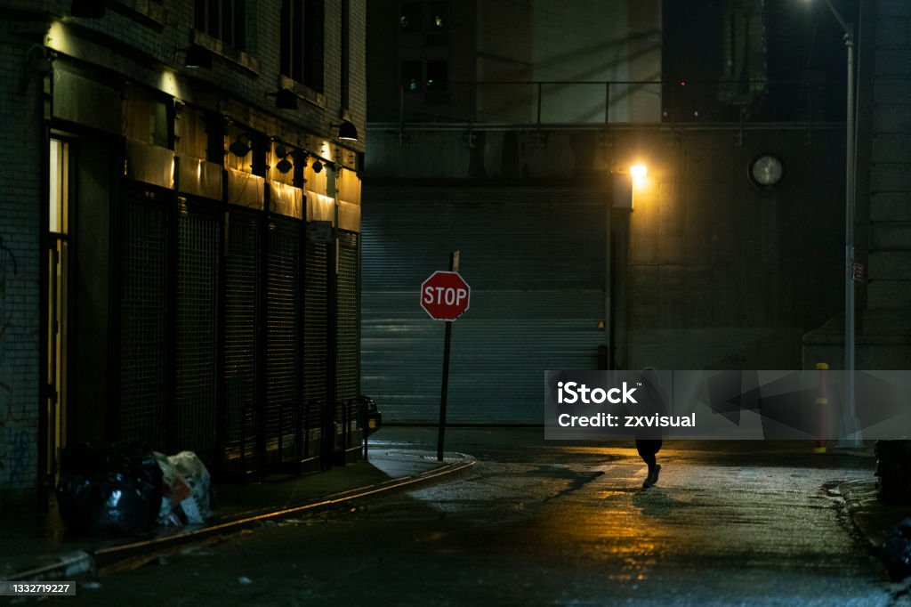 Dark Street Alley Dangerous looking street scene at night in New York City. Dark Stock Photo