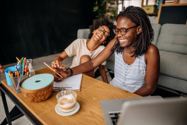 istock Mother and daughter studying online at home 1332720659