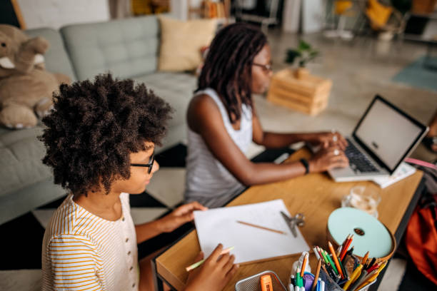 istock Mother helps her daughter with homework 1332720680