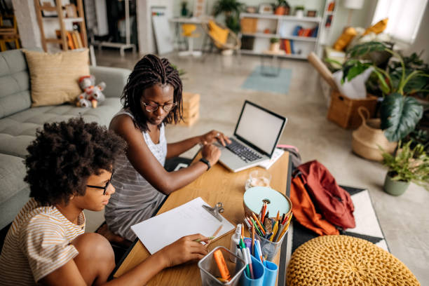 istock Mother helps her daughter with homework 1332720810