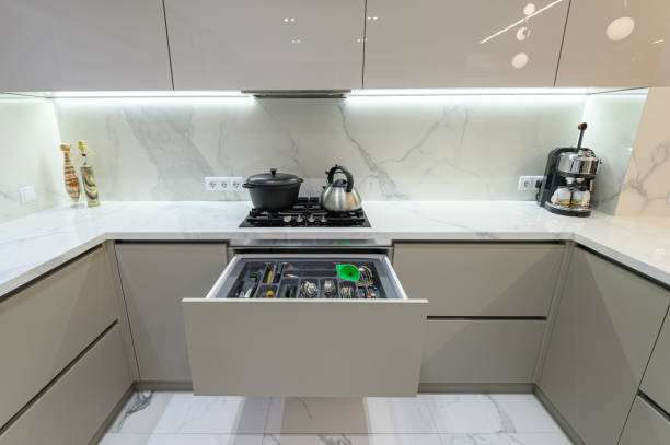 istock Open drawer with cutlery at modern white woden kitchen in classic style 1332721245