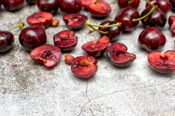 Closeup a pile of whole and halved ripe cherries
