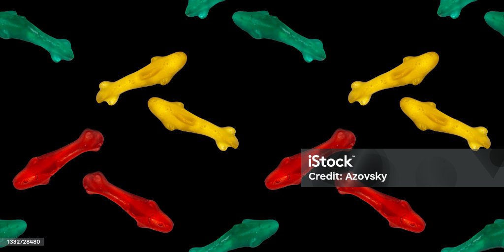 Seamless repeating pattern of marmalade eating sharks. Banner or wallpaper of edible sea fish on a black background. Abstract Stock Photo
