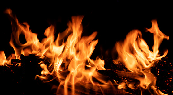 Fire burning on a black background. Ideal for compositing with another image. The background can be removed with a blending mode like screen.