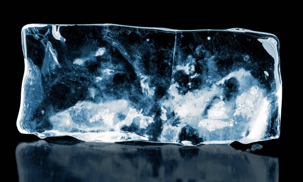 istock A big rectangular transparent piece of ice on black background. 1332730577