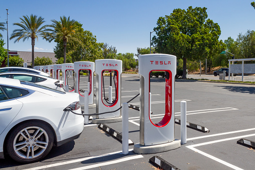 Brea, CA, USA – August 1, 2021: A white Tesla charging at Tesla Supercharger Station at the Brea Mall in Brea, California.
