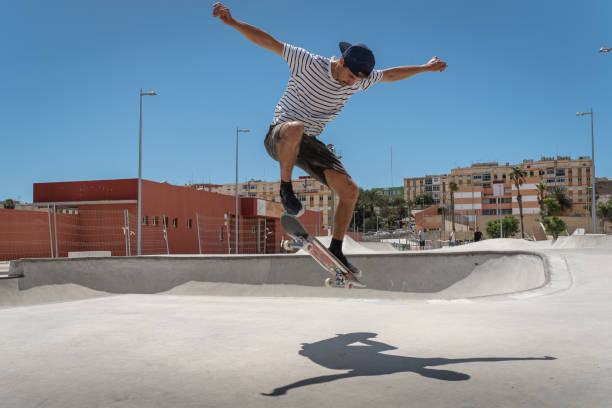 istock young man jumps with his skateboard in a skatepark 1332736583