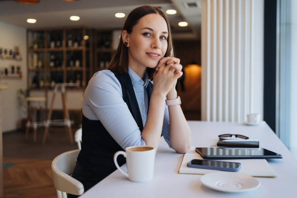 istock Thoughtful female sitting in cafeteria with a coffee while working 1332739146