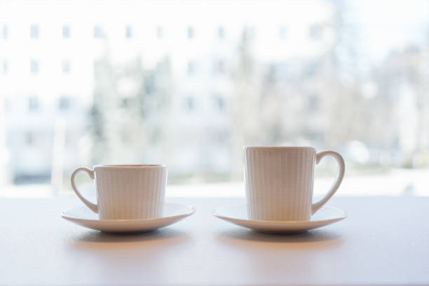istock Two cups of coffee on city background 1332739204