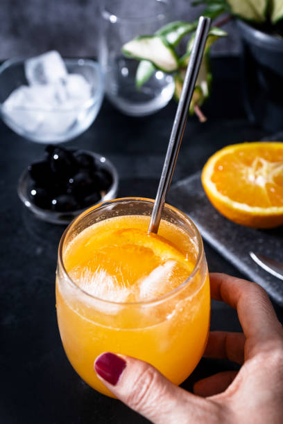istock Freshly squeezed orange juice with ice and an orange slice. Refreshing drink with vitamin C 1332740656