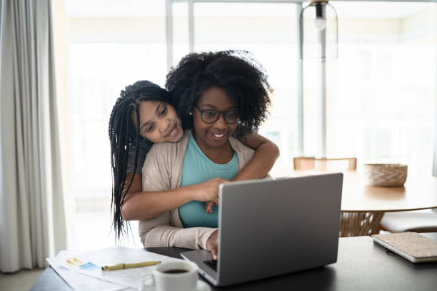 istock Girl embracing mother while she's working at home 1332741382