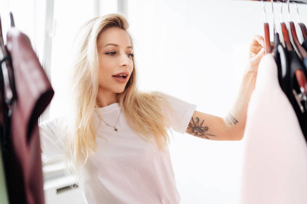 istock Beautiful young woman choosing clothes 1332741579
