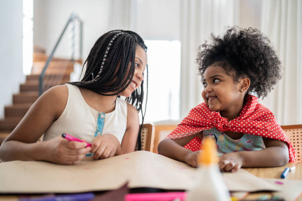istock Sisters preparing costume, drawing and doing art and craft at home 1332741668