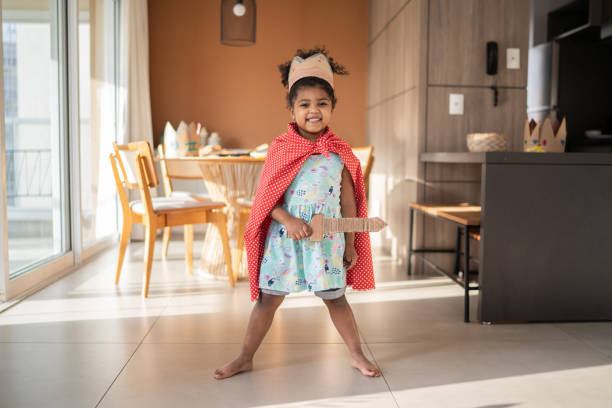 Portrait of a cute girl wearing crown playing at home Portrait of a cute girl wearing crown playing at home black knight stock pictures, royalty-free photos & images