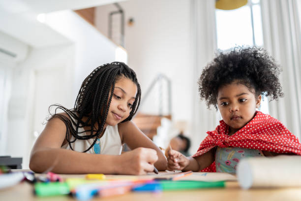 istock Sisters preparing costume, drawing and doing art and craft at home 1332741693