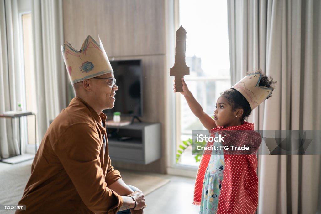 Father and daughter playing with superhero at home Child Stock Photo