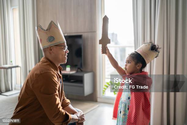 Father And Daughter Playing With Superhero At Home Stock Photo - Download Image Now - Child, Playful, Playing