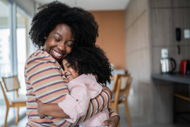 istock Mother and daughter embracing at home 1332742120