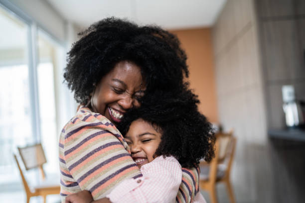 istock Mother and daughter embracing at home 1332742156