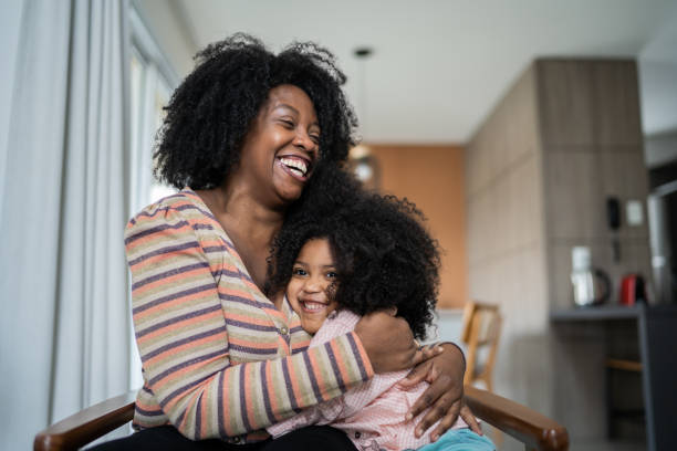istock Mother and daughter embracing at home 1332742191