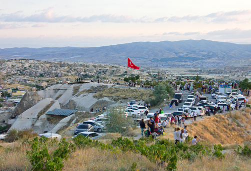 Nevşehir, Turkey - July 23, 2021：View of Love valley Goreme Cappadocia. There are many tourist watching hot air balloons which are traditional touristic attraction in Cappadocia.