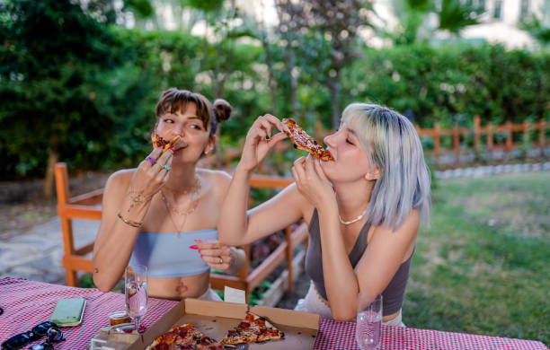 istock Best Friends having pizza party at outside 1332745768