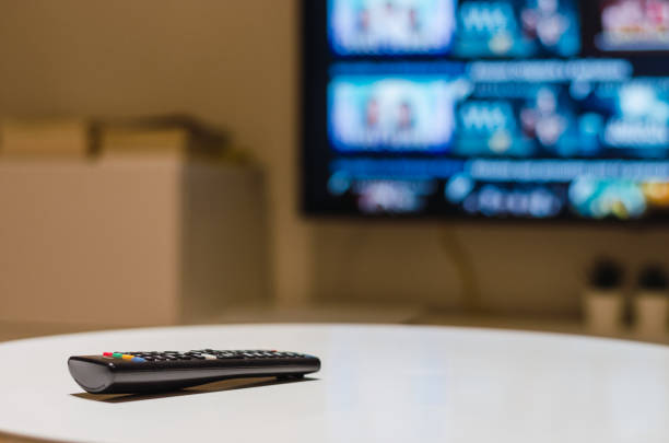 istock Remote control, smart tv and living room 1332748404