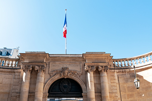 Paris : Hotel de Matignon entrance, with french flag. It's a State building of french administration, where the first minister (head of government\n) work, with all his team, senior official and official or public servant. Situated rue de Varenne in Paris, 7 th district – arrondissement – in France.