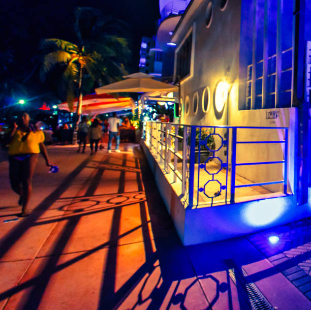 Miami, United States - October 06 2011 : an illuminated art deco building in Miami beach at night with huge shadows