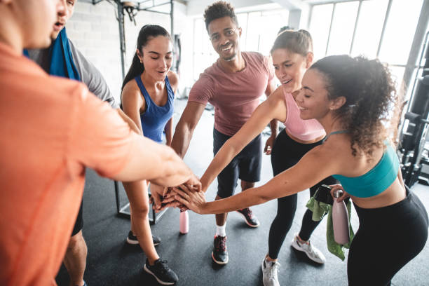 istock Gym Friends Acknowledging Strong Workout with Stacked Hands 1332764019
