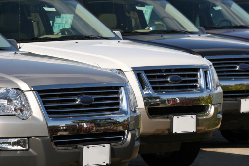 SUVs lined up at a car dealership.