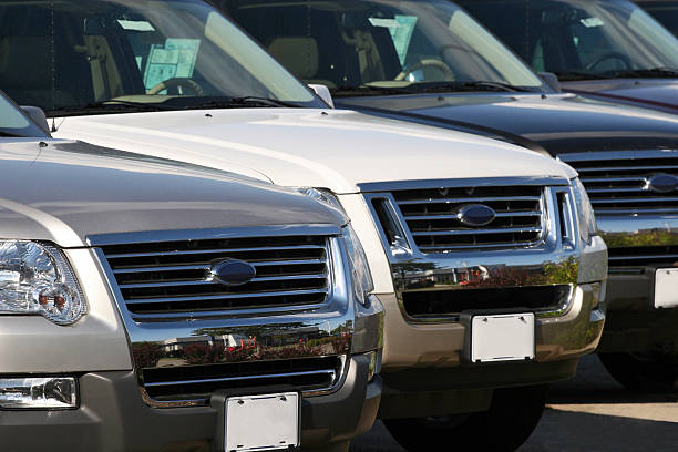 Car Dealership SUVs lined up at a car dealership. sports utility vehicle stock pictures, royalty-free photos & images