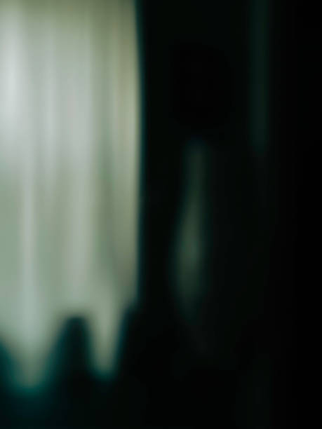 istock Abstract blurred background image with high contrasting white curtains and black wall 1332777020
