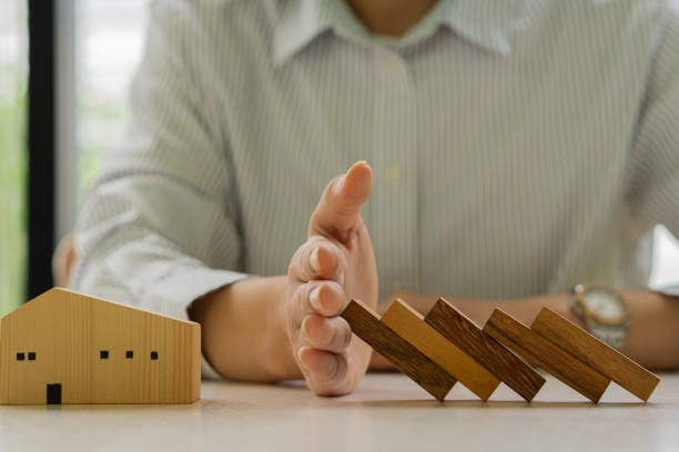 istock Businessman Stop falling wooden block domino from continuous falling or risk to construction business and strategy. Successful idea. 1332777975