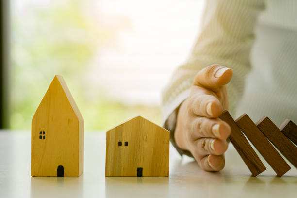 istock Businessman Stop falling wooden block domino from continuous falling or risk to construction business and strategy. Successful idea. 1332777976