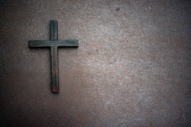 istock Barbed wire and wooden cross 1332778645