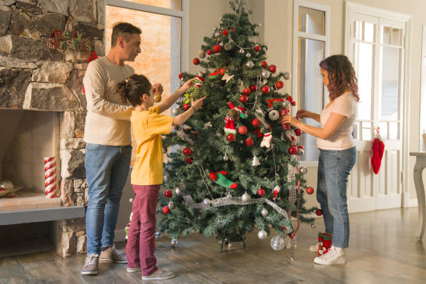 istock Father and mother decorating christmas tree with son  during summer christmas 1332785097