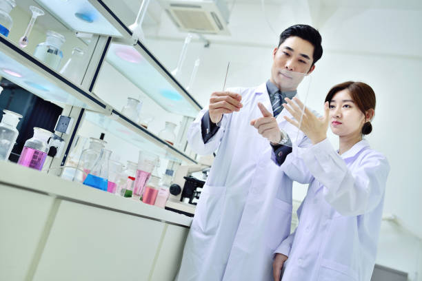 istock Two Scientist Working and Looking Digital Tablet at Laboratory 1332785235