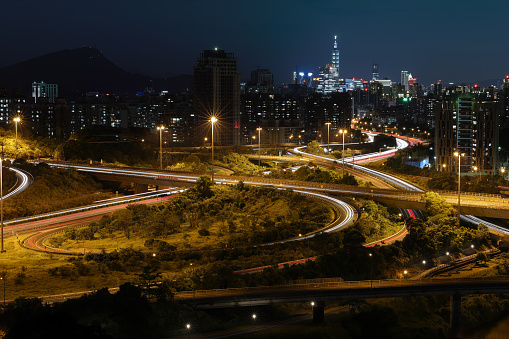 Taipei busy highway with city background at night