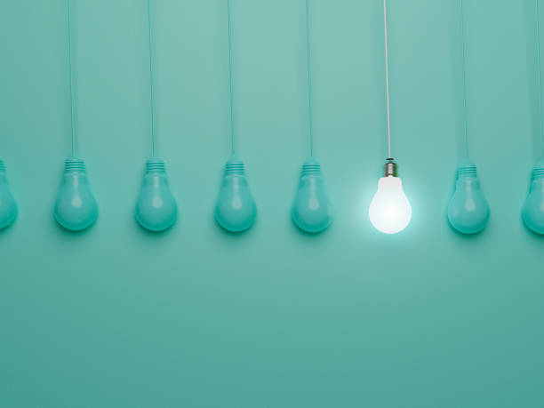 istock One hanging light bulb glowing from others bulbs on blue background for outstanding ,different creative thinking idea and innovation concept by 3d render. 1332788392