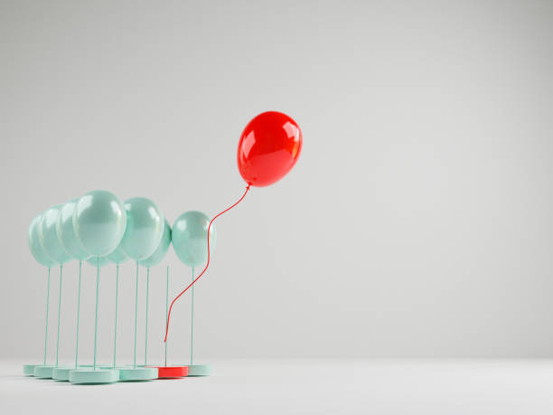 istock Red balloon floating out from blue balloons that are tied on white background , Performance outstanding from crowd for different thinking , disruption and leadership by 3D rendering. 1332788603