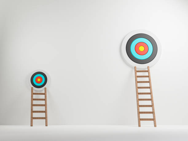 istock High and low ladder leaned towards to different target board on white background , small and big business project concept.3D render 1332789590