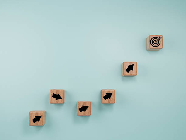 istock Virtual target board and arrow which print screen to wooden cube block on blue background. Business achievement goal and objective target concept. 1332790327
