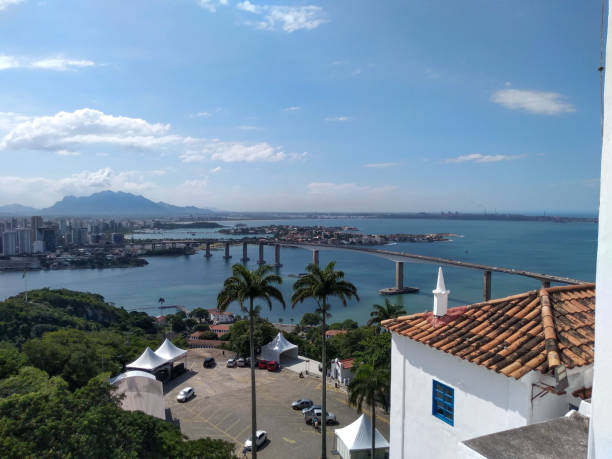 View of the city of Vila Velha and Vitória from the Convento da Penha. Tourist location. Convento da Penha is a place of great historical, religious and tourist importance. It is possible to have a beautiful view of the Brazilian cities of Vitória and Vila Velha. It is also possible to see the bridge connecting the two cities. convento stock pictures, royalty-free photos & images