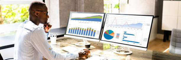 istock African American Business Desktop Looking At Graphs 1332792404