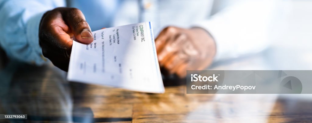 African Business Man Giving Paycheck African Business Man Giving Paycheck Or Payroll Cheque Paycheck Stock Photo