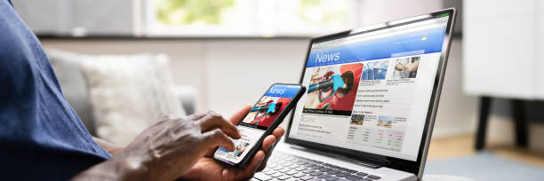 istock Watching Online News Article On Mobile Phone 1332793343