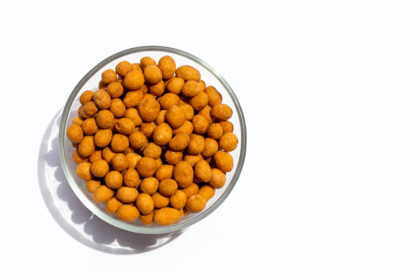 Crispy peanut snack balls on white background.