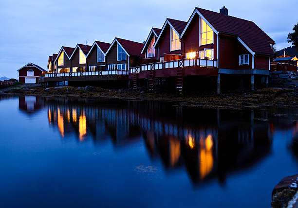 Red wooden cabins at campsite by the fjord in Molde, Norway