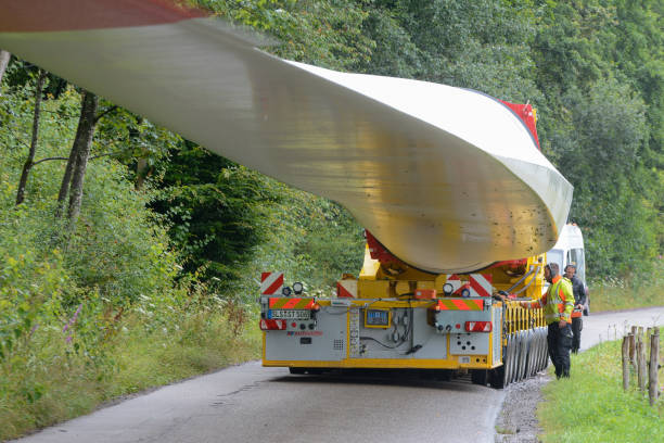 Lahr, Baden-Wuerttemberg, Germany, August 3, 2021: A rotor blade (69 meters, 20 tons) of a wind turbine is transported to the construction site on Langehard over narrow streets and through the village of Sulz.